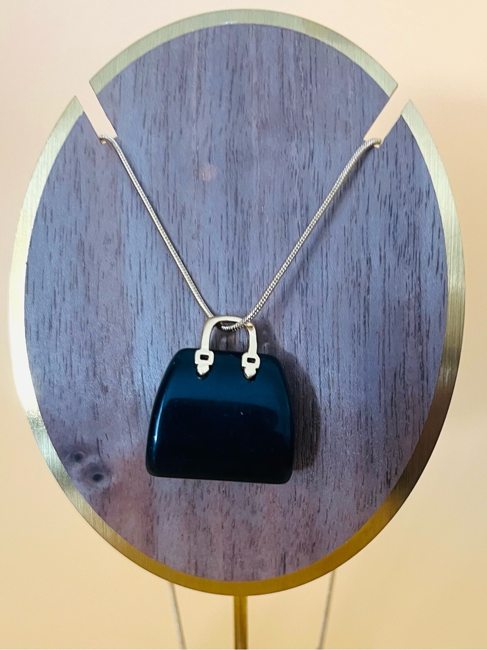 Black stone Purse design pendant plus a gold plated pendant